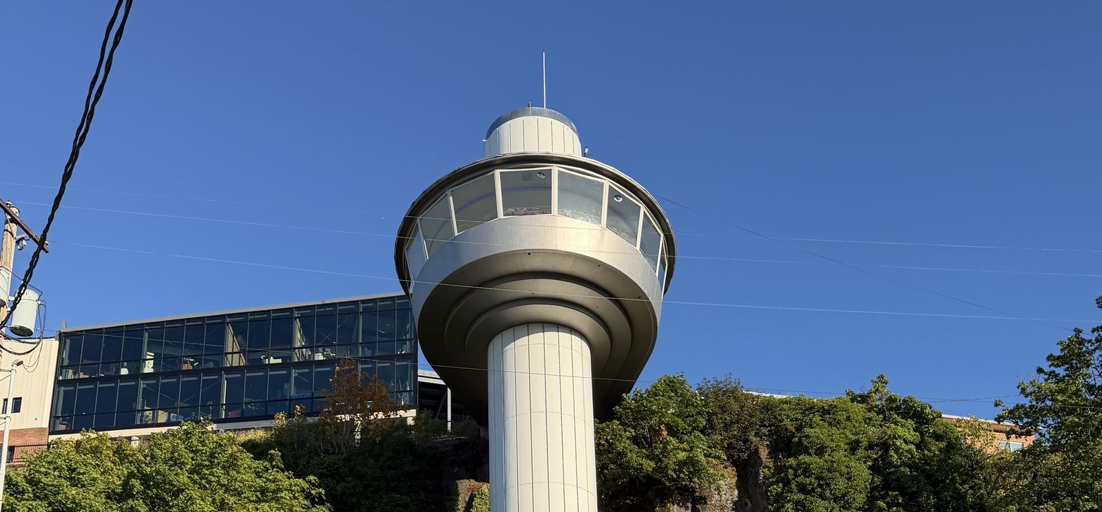 The Oregon City Municipal Elevator, a 130-foot concrete tower with a round glass observation deck, rising above the basalt bluff in Oregon City, Oregon